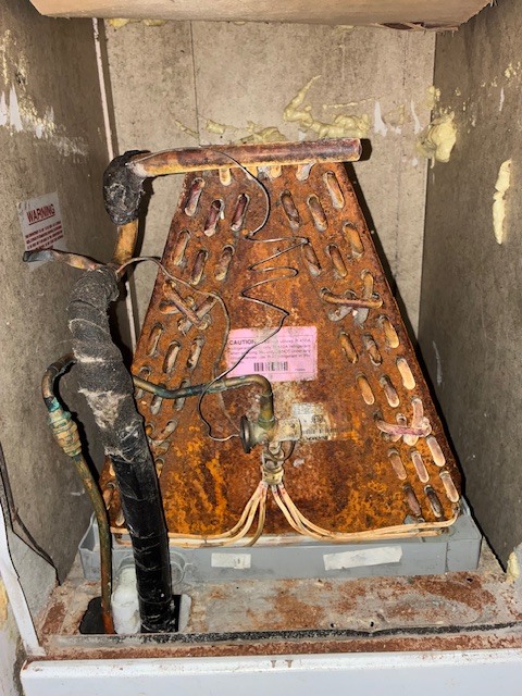 Severely rusted and deteriorated evaporator A-coil before replacement