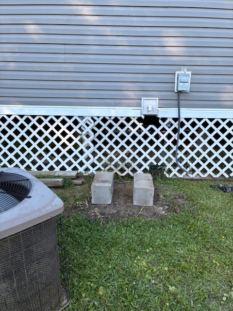 Empty pad with cinder blocks before new outdoor AC condensing unit installation